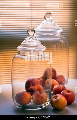 High angle close up of empty glass jars with wooden wicks, for candle making.  Stock Photo by Mint_Images