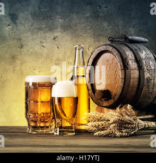 Barrel and beer glasses on the table tinted in yellow and blue Stock Photo
