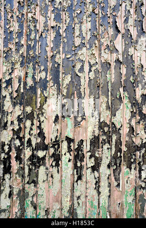 Old flaking paint peeling from a metal surface showing obvious signs of rot and decay. Stock Photo
