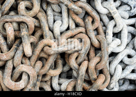 Aged and worn rusty metal chains in a loose pile Stock Photo