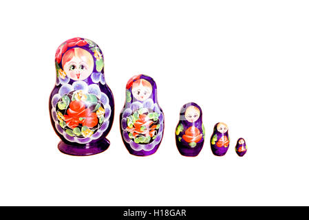 Row of brightly colored Russian Matryoshka Dolls set against a white background Stock Photo