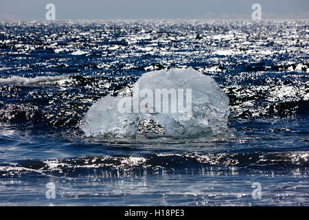 Iceberg washing up on black sand beach at jokulsarlon iceland Stock Photo