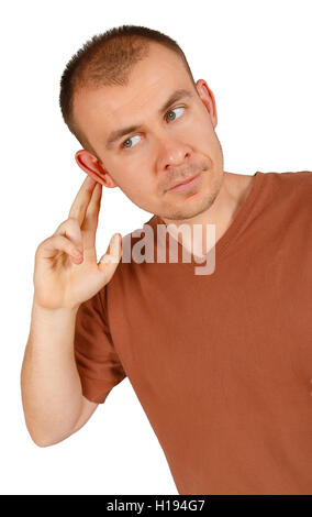 Young man holding hand on his ear isolated on white background Stock Photo