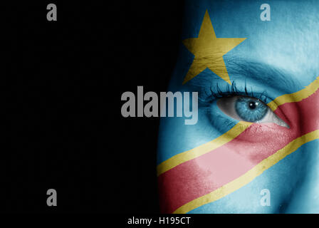 A young female with the flag of Congo Democratic Republic painted on her face on her way to a sporting event to show her support Stock Photo