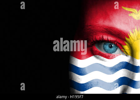 A young female with the flag of Kiribati painted on her face on her way to a sporting event to show her support. Stock Photo