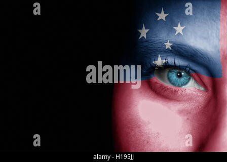 A young female with the flag of Samoa painted on her face on her way to a sporting event to show her support. Stock Photo