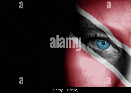 A young female with the flag of Trinidad and Tobago painted on her face on her way to a sporting event to show her support. Stock Photo