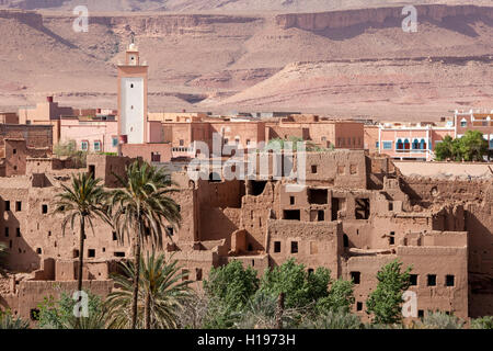 Tineghir, Morocco.  Palmeraie Oasis Scene.  Abandoned Traditional Houses in Foreground, Modern Houses in Background. Stock Photo
