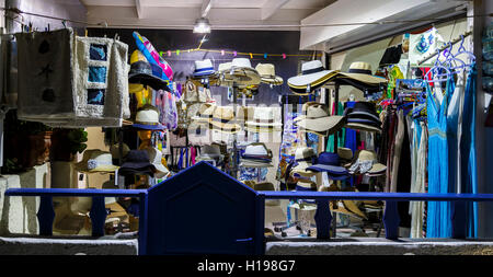 A souvenir shop selling hats, at night, Oia, Santorini, a Mediterranean Greek Island in the Cyclades group Stock Photo