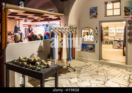 Fabrics and souvenirs on display in a shop in Oia, Santorini, a Mediterranean Greek Island in the Cyclades group Stock Photo