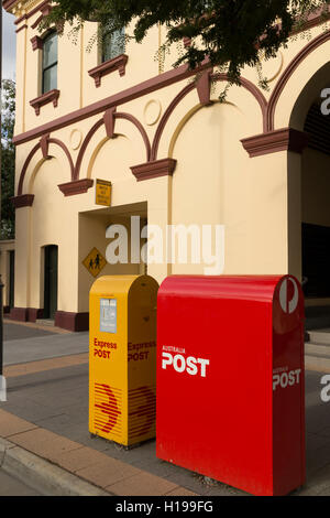 Snail mail and express post yellow and red boxes outside the  post office Albury NSW Australia