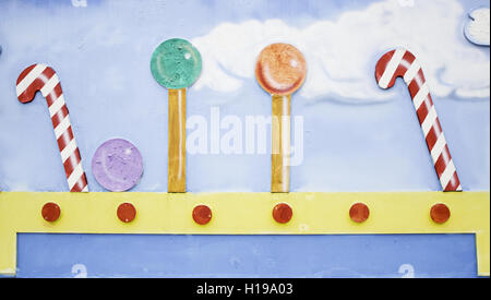 Candy canes and lollipops in urban wall, sweets Stock Photo