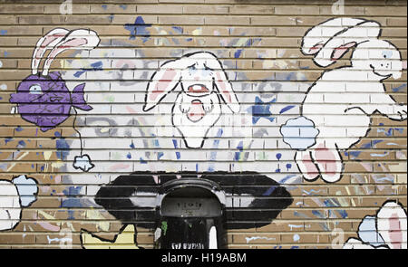 Rabbits in hat drawn on urban wall decoration Stock Photo