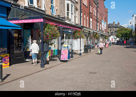 People shopping shoppers in the town centre shops stores in summer Oxford Street Harrogate North Yorkshire England UK United Kingdom GB Great Britain Stock Photo