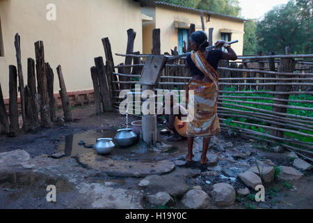Women fetching water from handpump, Muria Tribe, Erdku village, Chattisgarh, India Stock Photo