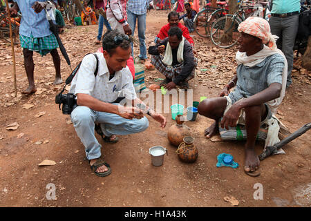 Vendor selling Madi (Natural Liquor) Dhurwa Tribal Market, Pandripani Village, Chattisgadh, India Stock Photo