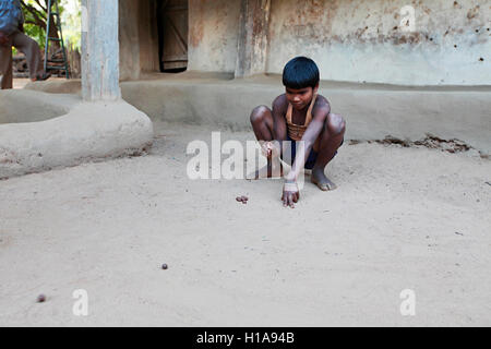 A child playing game of marbles, Erdku Village, Chattisgarh, India Stock Photo