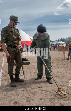 Man - visitor of show tries on the sapper suit Stock Photo