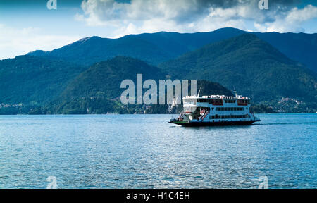 Varenna, Italy - September 4th, 2015: a ferry carries passengers across Lake Como, Italy. Photographed in Varenna on September 4 Stock Photo