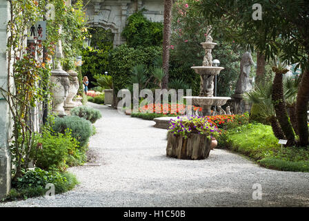 Varenna, Italy - September 4th, 2015: woman walking through the botanical garden at Villa Monastero in Varenna, Italy. Stock Photo