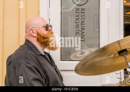Drummer playing outside during Menningarnott- The Cultural Festival in Reykjavik, Iceland Stock Photo