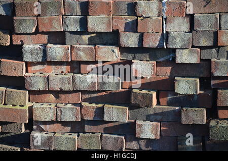 A stack of used red bricks. Stock Photo
