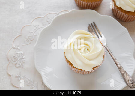 rose flower vanilla cupcakes on vintage plate Stock Photo