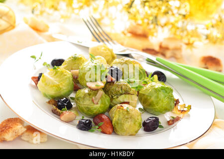 Baked Brussels sprouts with almonds and grapes for holidays. Stock Photo