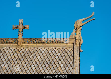 Roof detail with wood shingles, wooden cross and dragon head, Stave Church Lom, Lom, Oppland, Norway Stock Photo