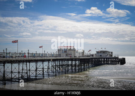 Worthing Pier during low tide on a sunny day in Worthing, West Sussex, England. Stock Photo