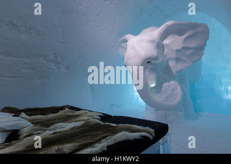 Bed with reindeer skins, Elephant In The Room suite, designed by Annasofia Maag, Icehotel, Jukkasjärvi, Norrbotten County Stock Photo