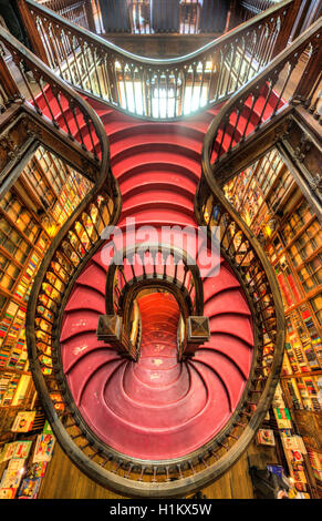Curved wooden staircase in library, Livraria Lello & Irmão bookstore, Porto, Portugal Stock Photo