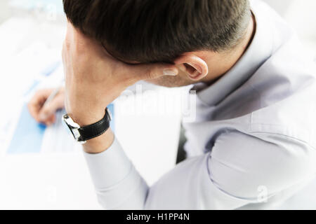 close up of businessman with laptop and papers Stock Photo