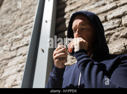 close up of addict smoking marijuana joint Stock Photo