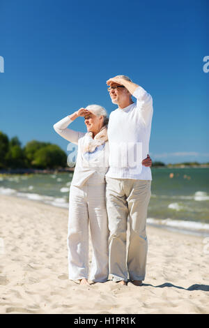 happy senior couple hugging on summer beach Stock Photo