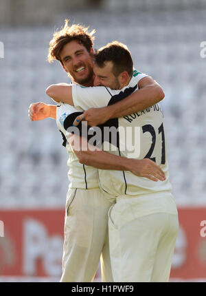 Middlsex's bowler Toby Roland-Jones with Steven Finn (left) celebrates taking the final wicket of Yorkshire's Ryan Sidebottom to win the County Championship during day four of the Specsavers County Championship, Division One match at Lord's, London. Stock Photo