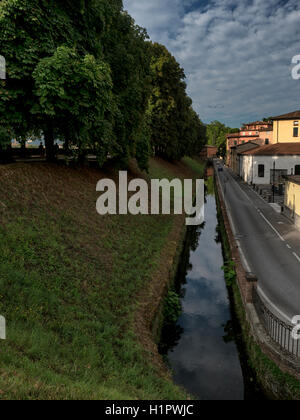Ancient walls and old moat, now a canal, in Lucca, Tuscany, Italy Stock Photo