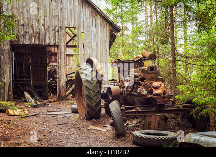Image of rusty old tractor, abandoned in the forest. Kyrko Mosse, Sweden. Stock Photo