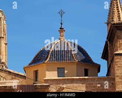Blue ceramic tiles covering one of the small domes of Cathedral Valencia Espana Spain with clear blue sky as backdrop Stock Photo