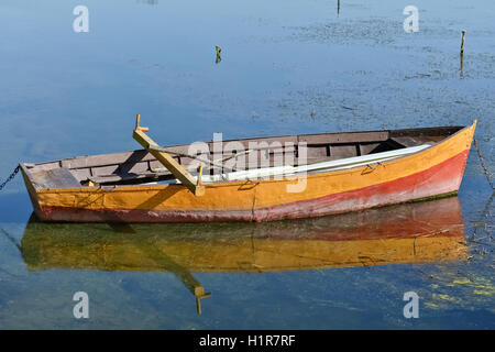 The yellow single fishing boat in the pond, close-up Stock Photo