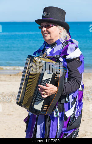 Anonymous Morris dancer playing Hohner accordion at Swanage Folk Festival, Dorset UK in September - accordion being played Stock Photo