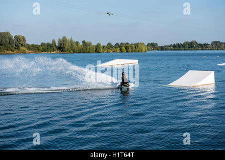 young man on wakeboard is ready to jump Stock Photo