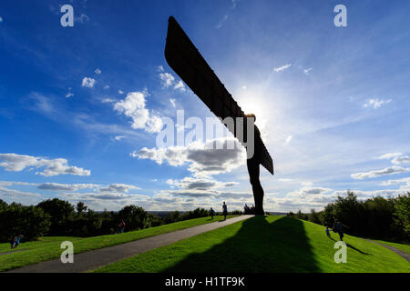 View of the Angel of the North statue with blue sky and white clouds.