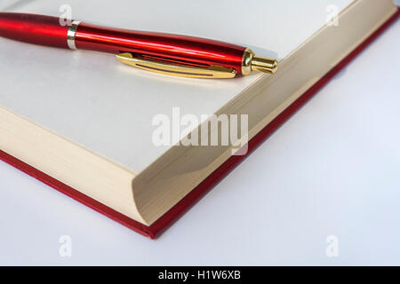 Ballpoint Pen Lying On Open Book Stock Photo