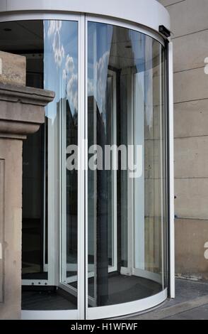 Modern revolving door as entrance to office building or hotel Stock Photo
