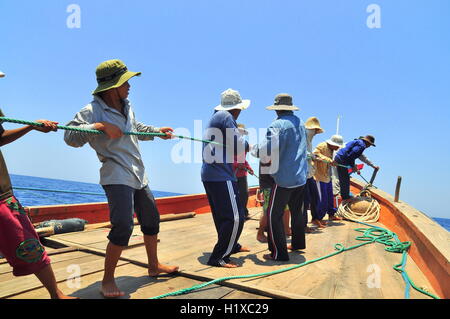 Nha Trang, Vietnam - May 5, 2012: Fishermen are catching tuna with a trawl net. Stock Photo