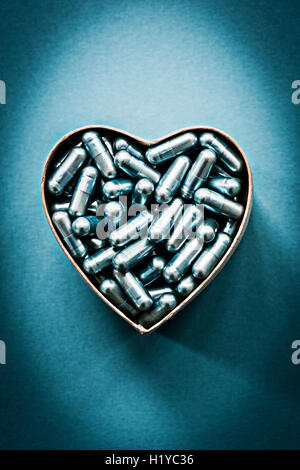 Generic pills and capsules in heart shape. Stock Photo