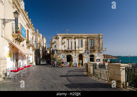 SYRACUSE, ITALY - SEPTEMBER 14, 2015: Small italian street with cafe. The island of Ortygia in Syracuse, Sicily Stock Photo