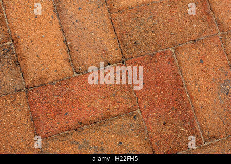 rough old orange bricks used as pavers Stock Photo