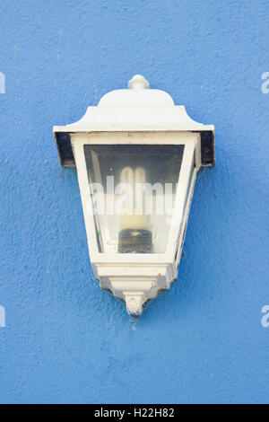 White lantern on blue wall Stock Photo